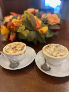 Two bowls of French onion soup with spoons