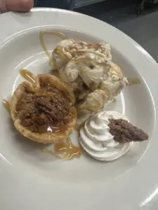 Pecan tart with ice cream and whipped cream