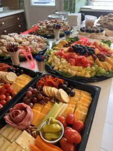 Assorted charcuterie and fruit platters on table