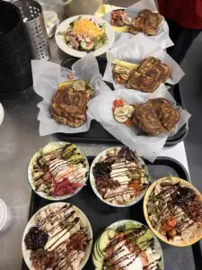 Assorted grilled sandwiches and drizzled poke bowls
