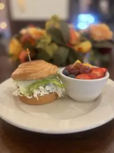 Bagel sandwich with fresh fruit bowl