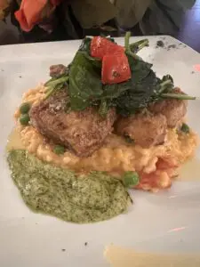Crispy fish on creamy risotto with pesto